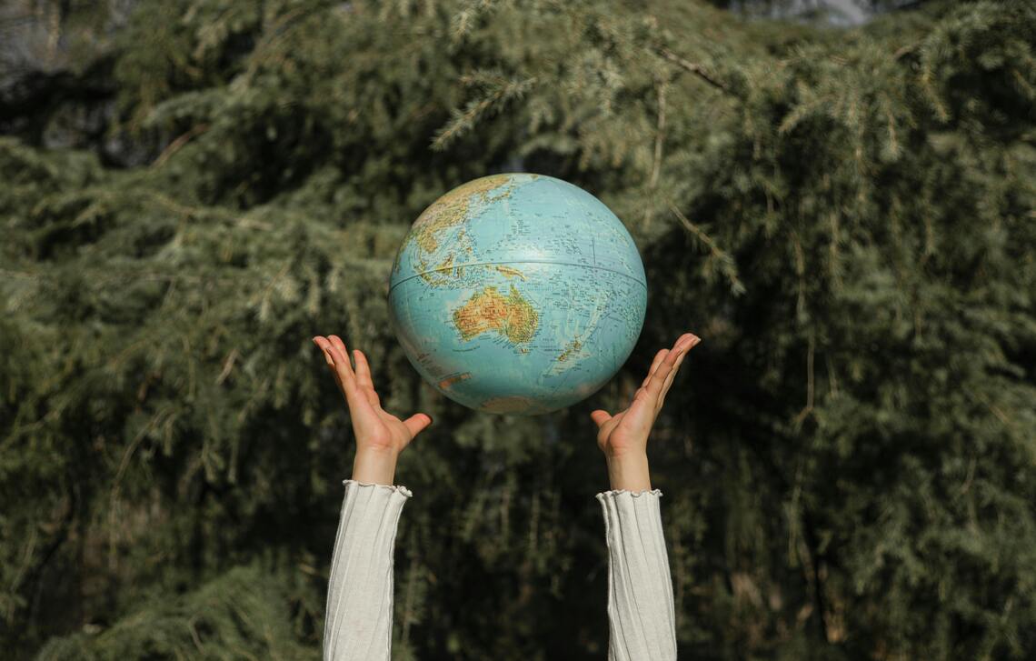 A person throwing a globe.